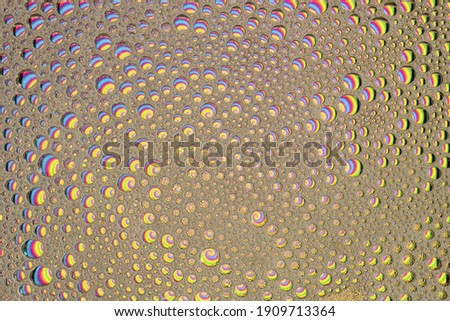 Rainbow Suds Wallpaper Background Texture. Bubbles containing lots of vibrant beautiful colors. Abstract fun image.