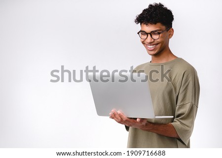 Smart young mixed-race student using laptop isolated over white background