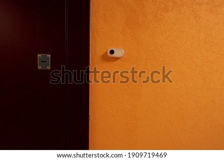 A typical ordinary corridor of a residential building, painted in bright colors, metal unnamed apartment doors, rich shades