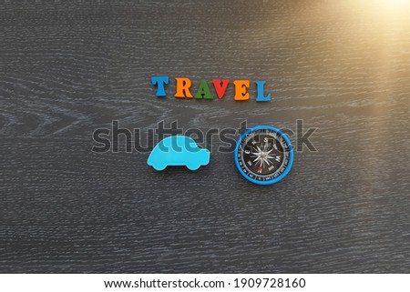 Car blue color, compass, journey, on a dark background. Tourism, recreation.