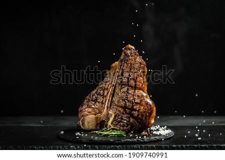 The T-bone or porterhouse steak of beef cut from the short loin. steaksT-shaped bone with meat on each side. banner, catering menu recipe place for text. Royalty-Free Stock Photo #1909740991