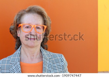 Mature entrepreneur wearing orange outfit