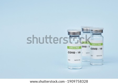 Three cans of coronavirus vaccine. on a blue background. copy space, banner