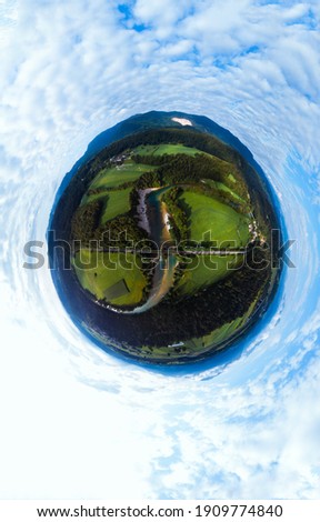 Aerial little planet view of the railway connection. Summer, sunny weather. Metal bridge over a mountain river. Transport and freight transportation concept. Vertical photo. Misace, Slovenia.