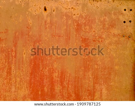 texture of brush marks on an orange sheet of iron
