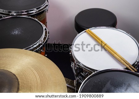 
Closeup of drumsticks lying on the professional drum set. Drummer equipment. 
