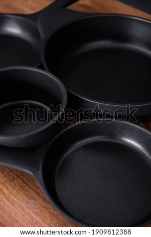 Set of grill pans on wooden table background