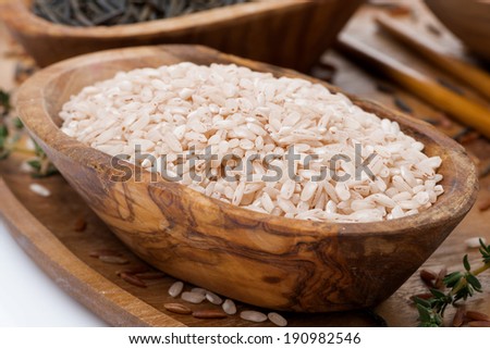 pink unpolished rice in a wooden bowl, close-up, horizontal