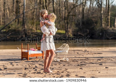 A beautiful young mother and her daughter enjoy the spring weather