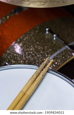 
Closeup of drumsticks lying on the professional drum set. Drummer equipment. 
