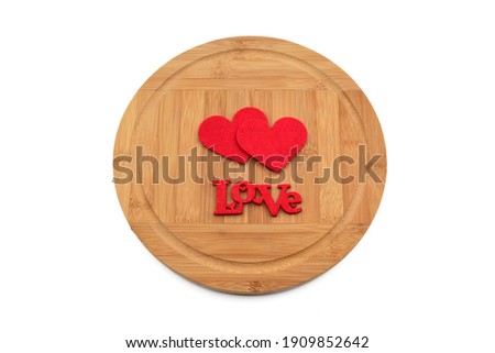 Round bamboo serving board and hearts with love letters, isolated on white background
