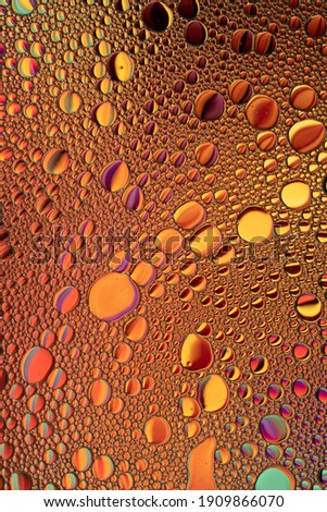 Orange and Purple Oil and Water Abstract Wallpaper Background Texture. Oil Bubbles and blobs containing lots of bright vibrant beautiful colors. Unique fun image.