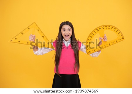 surprised kid girl use protractor and triangle to learn mathematics, measurement.