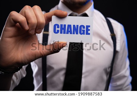 Businessman hand holding card with CHANGE word. success, strategy, solution, business and Positive thinking concepts.