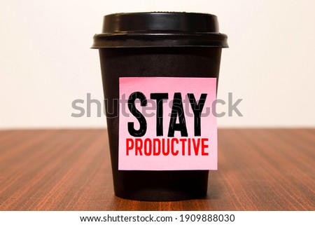 Conceptual hand writing showing Stay Productive Motivational Call. Business photo text Efficiency Concentration Productivity Text white paper hand black marker coffee glass letter.