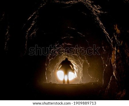 surreal moody photo of the man in the cave