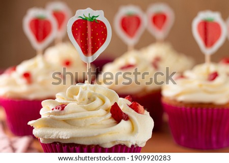 Tasty strawberry cupcakes. Image with selective focus.