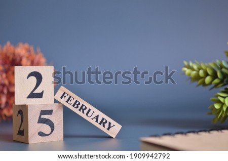 February 25, Cover in the evening time, Date Design with number cube for a background.