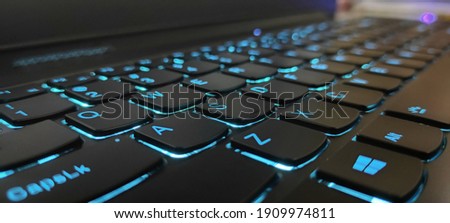Keyboard Laptop with Blue Backlight Royalty-Free Stock Photo #1909974811