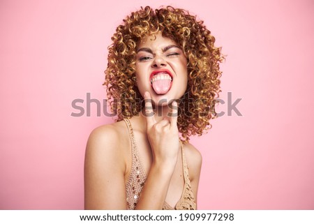 Beautiful woman Curly hair shows tongue hand gesture sequin shirt