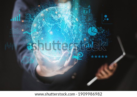 Business man wearing a suit using a tablet hand presenting cyber business world graphics In the business technology model, the concept of digital business processing Royalty-Free Stock Photo #1909986982