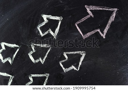 Arrows drawn in chalk on the board. Leadership concept Royalty-Free Stock Photo #1909995754