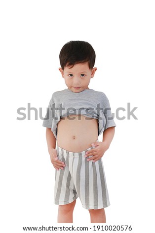 Portrait of Asian baby boy age about 3 years old lifting his shirt show exposing his big tummy isolated on white background. Royalty-Free Stock Photo #1910020576