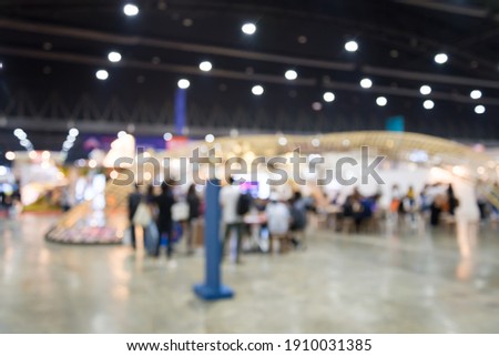 Abstract blur people in exhibition hall event trade show expo background. Large international exhibition, convention center, business marketing and event fair organizer concept. Royalty-Free Stock Photo #1910031385