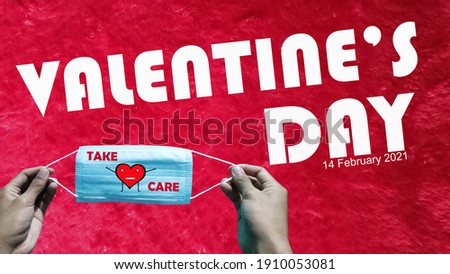 Valentine`s day, a mask with the words `take care` cartoon drawing of red love shape held by a man`s hand on a red carpet background.