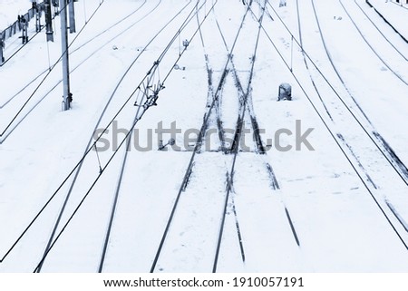 Railway top view background. Train track texture. White transportation background. Winter landscape. Snow on the railway. Icy train plaftorm. Train station covered in snow.
