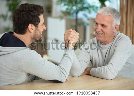 men having a friendly arm wrestle