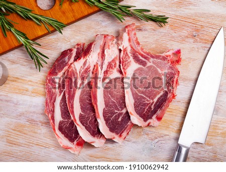 Close up of raw pork's chops on wooden table, no people