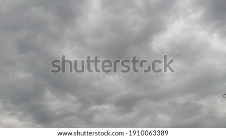 Black clouds hanging in the sky are a sign of overcastity Royalty-Free Stock Photo #1910063389