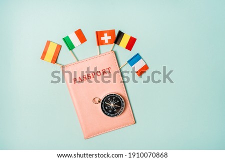 Travel concept passport from which the flags of different European countries stick out. The opportunity to travel to the countries of the Schengen Union.