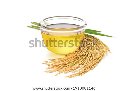 Rice bran oil with rice ears and leaves  isolated on white background. Royalty-Free Stock Photo #1910081146