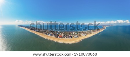 Aerial view of the spit (landform) with city. Seascapeю Еhe sea, and shore. Horizontal panorama