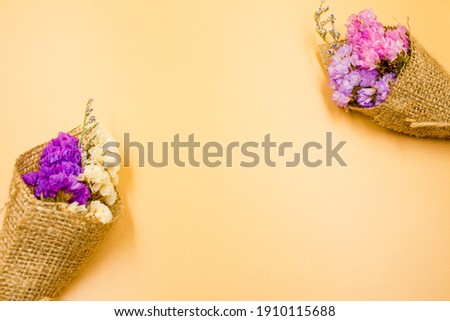 Statis dried flowers in the bouquet, Vintage Style, Colorful dried Statis flowers, Limonium spp, Orange background.