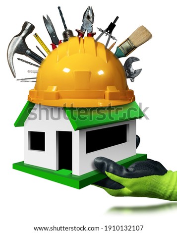 Hand with protective work glove showing a small model house with yellow hard hat and work tools above the green roof. Isolated on white background with reflections.
