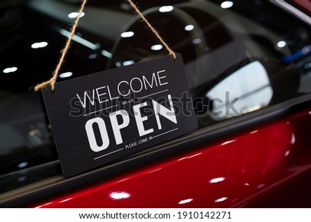 open car  with red car in dealership for door car  ideas unlock freedom tourist travel for lifestyle customer from salesman sign welcomenew normol during Coronavirus disease covid-19 unlock lockdown