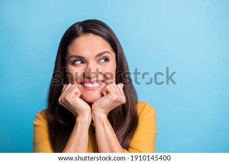 Photo portrait of smiling woman wearing yellow clothes looking blank isolated on vivid blue color background