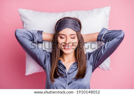 Photo portrait of pretty brunette wearing pajama relaxing after hard day laying on pillow isolated on pastel pink color background Royalty-Free Stock Photo #1910148052