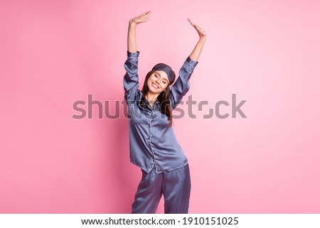 Photo portrait of cute girl stretching in morning isolated on pastel pink colored background Royalty-Free Stock Photo #1910151025