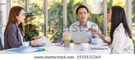 Group of Asian business people wearing formal clothes sitting around working table. Meeting talking discussing listening about company business to the colleague in the office.