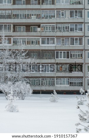 Winter cityscape, facade of an apartment building in Russia. Vertical photo