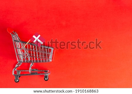 Shopping cart and Denmark flag on red background. Shopping online or eCommerce, delivery service store