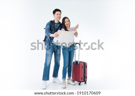Young couple packing for vacation travel on isolated. Young Asian man and women are preparing for the journey happily on white background. Royalty-Free Stock Photo #1910170609