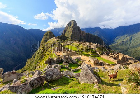 Machu Picchu, the most familiar icon of Inca civilization situated on a mountain ridge above the Sacred Valley northwest of Cuzco, Cusco Region, Peru. Royalty-Free Stock Photo #1910174671