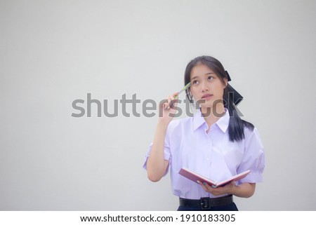 Portrait of thai high school student uniform beautiful girl Think