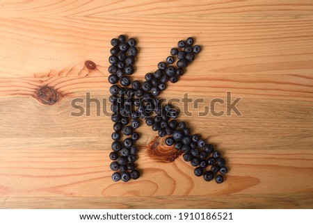 Letter K made of blueberry