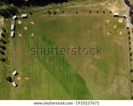 High Aerial view of green grassed sporting fields, baseball and softball, sunny summer day, no people, Surveyors Creek, Glenmore Park, NSW, Australia